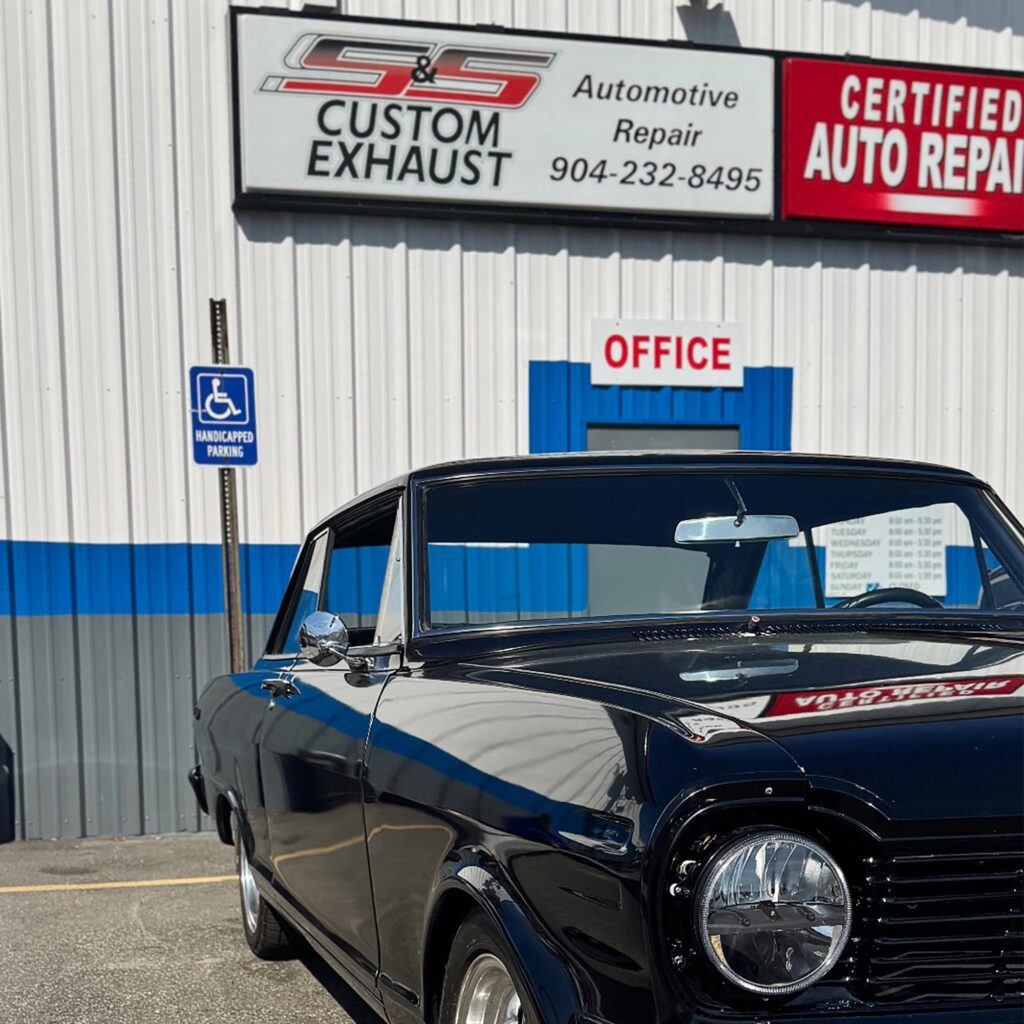 Exterior of an auto repair shop with a vehicle parked outside the office entrance